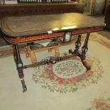 An ormolu mounted table with porcelain plaques and leather inset top.