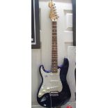 A left handed Fender Stratocaster with soft case.