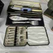 A decorative cased set of fish servers, a cased carving set and a set of 6 cased cake forks.