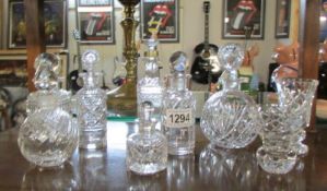 7 cut glass scent bottles and 2 posy vases.