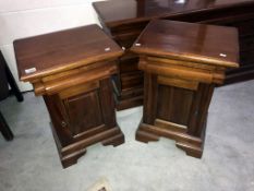 A pair of antique bedside cabinets