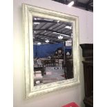 A coloured framed mirror