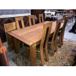 A wooden dining table and 6 unusual shaped wooden dining chairs