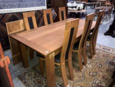 A wooden dining table and 6 unusual shaped wooden dining chairs