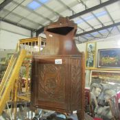 A small hanging corner cupboard.