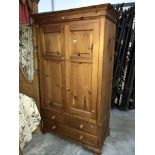 A pine double wardrobe with bottom drawers