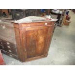 A mahogany corner cupboard