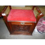 An Edwardian piano stool with drop down front.