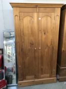 A solid pine double wardrobe