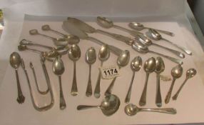 26 items of silver including sugar nips, teaspoons etc., approximately 440 grams.
