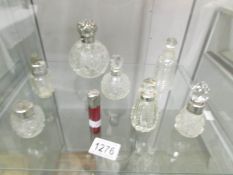 A mixed lot of silver topped bottles including cranberry example.