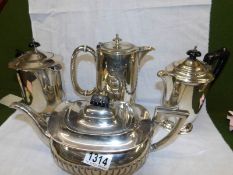 A silver plate teapot and 3 silver plate hot water jugs.