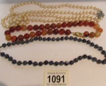 3 vintage necklaces, one cornelian stone, one sodalite stone and the other a row of pearls.