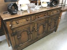 A 1950's carved oak sideboard