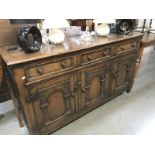 A 1950's carved oak sideboard