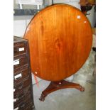 A Victorian mahogany tip up dining table