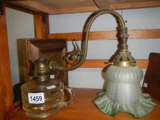 A hand oil lamp and a wall light.