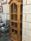 A light oak display cabinet