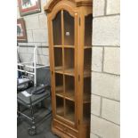 A light oak display cabinet