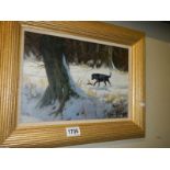 A John Trickett (B.1953) oil on canvas painting of a black labrador retrieving in the snow. Signed.