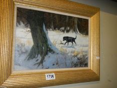 A John Trickett (B.1953) oil on canvas painting of a black labrador retrieving in the snow. Signed.