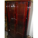 A modern dark wood stained display cabinet.