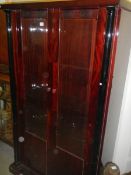 A modern dark wood stained display cabinet.