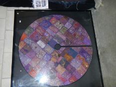 A large framed & glazed Eastern silk circular patchwork table cloth.