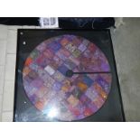 A large framed & glazed Eastern silk circular patchwork table cloth.