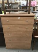 A light wood effect 5 drawer bedroom chest