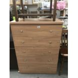 A light wood effect 5 drawer bedroom chest