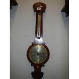 A Victorian mahogany wheel barometer with silvered dial.