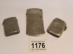 2 silver vesta cases and a silver card case, approximately 80 grams.