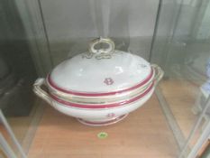A large monogrammed soup tureen.