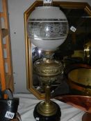 An embossed brass oil lamp.