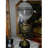 An embossed brass oil lamp.