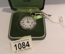 A vintage silver fob watch with key.