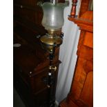 A wrought iron standard oil lamp complete with font.