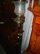 A wrought iron standard oil lamp complete with font.