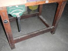 A wood work bench with vice