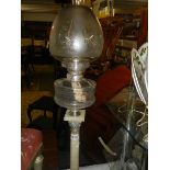 A Victorian silver plate Corinthian column oil lamp.