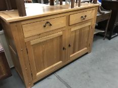 A modern solid oak 2 drawer 2 cupboard dresser base