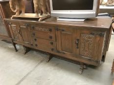 An oak rustic sideboard with iron handles