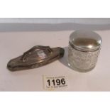 A silver nail buffer and a glass pot with silver lid,.