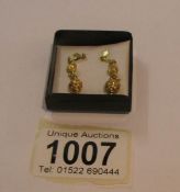 A pair of 9ct gold pendant earrings.