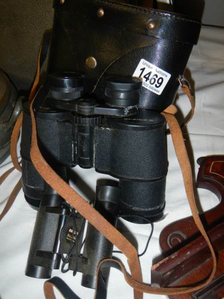 A cased pair of binoculars and one other.