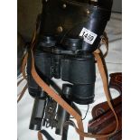 A cased pair of binoculars and one other.
