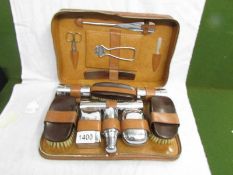 A 1930's gentleman's travelling vanity set with plaque inscribed 'S.W.G.B. 24th Dec. 1937'.