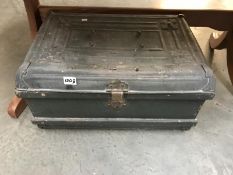 An ornate vintage metal travel trunk