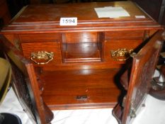 A smokers cabinet, one handle broken.